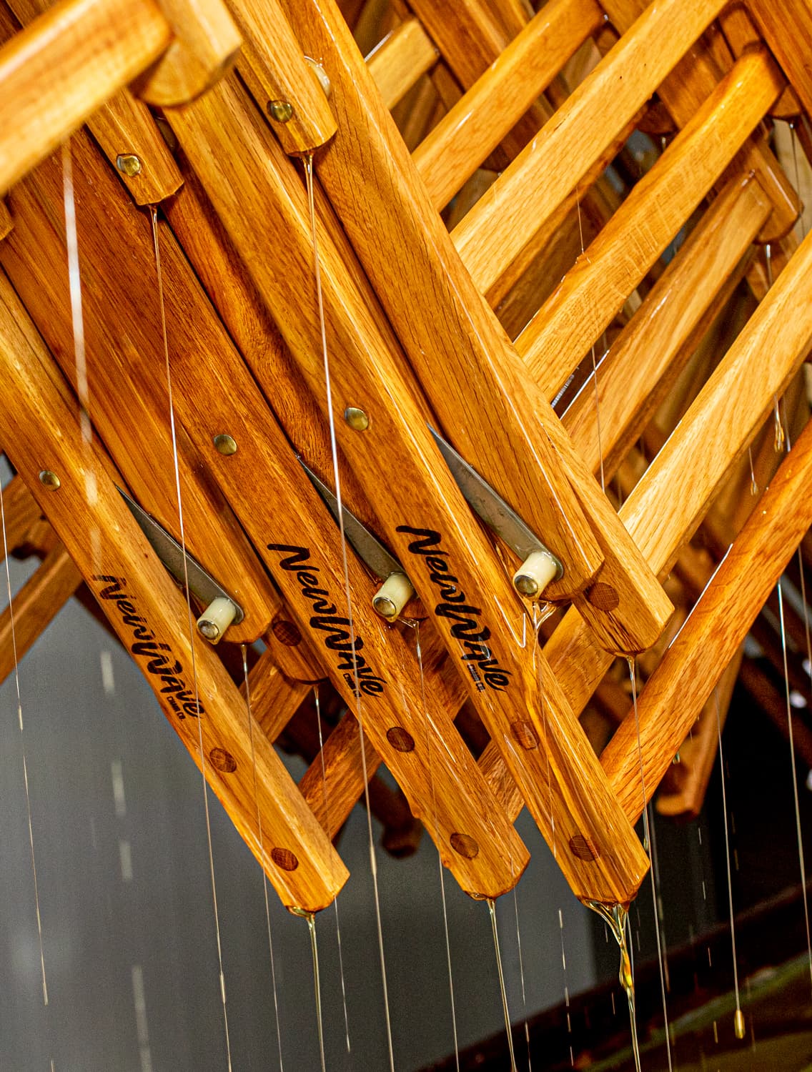 Varnished oak chair frames hanging to dry