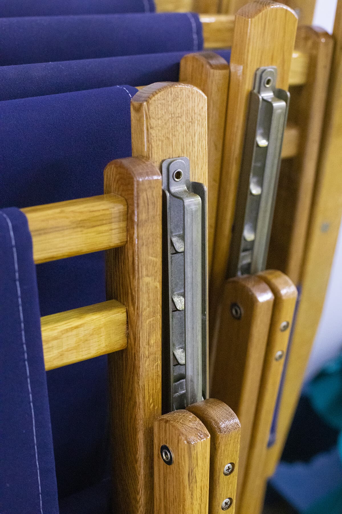 Folded chairs showing the stainless recline hardware on oak frames